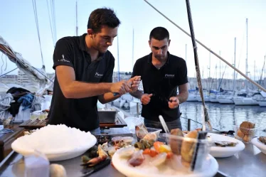 Deux écaillers de Pierrot Coquillages composent un plateau de fruits de mer et ouvrent des huîtres fraîches. traiteur marseille